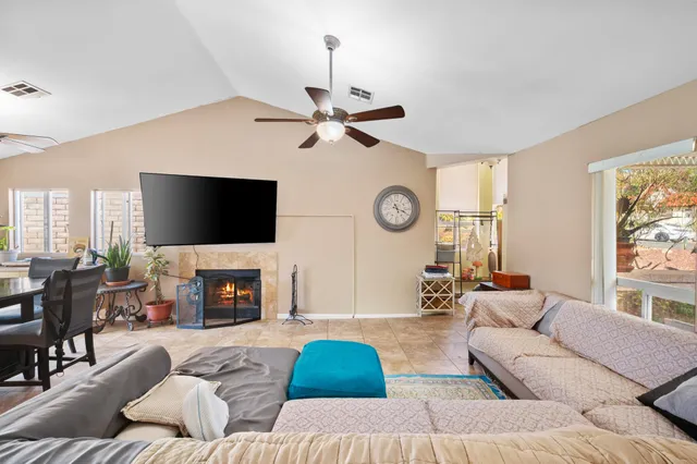 a living room with furniture a fireplace and a flat screen tv