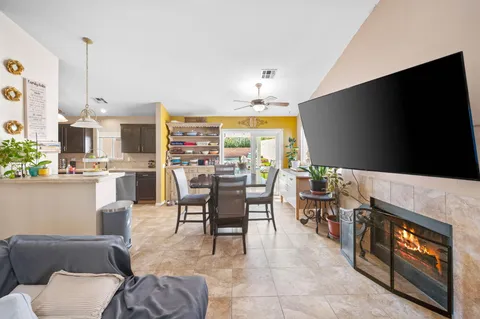a living room with fireplace furniture and a flat screen tv