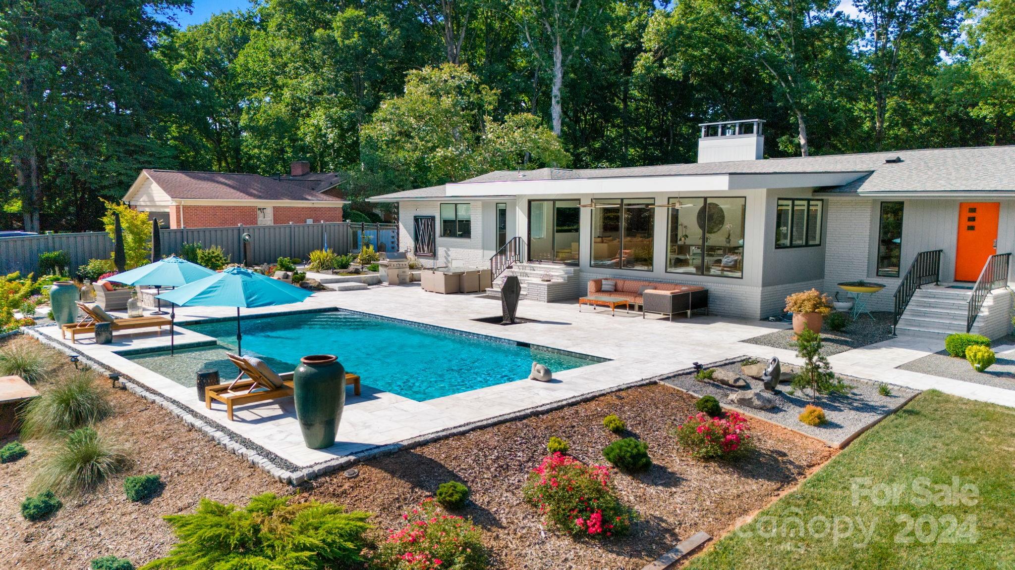 4142 Oldfield Road Charlotte, NC 28226 - Photo 1 of 48 a view of a house with sitting area and garden
