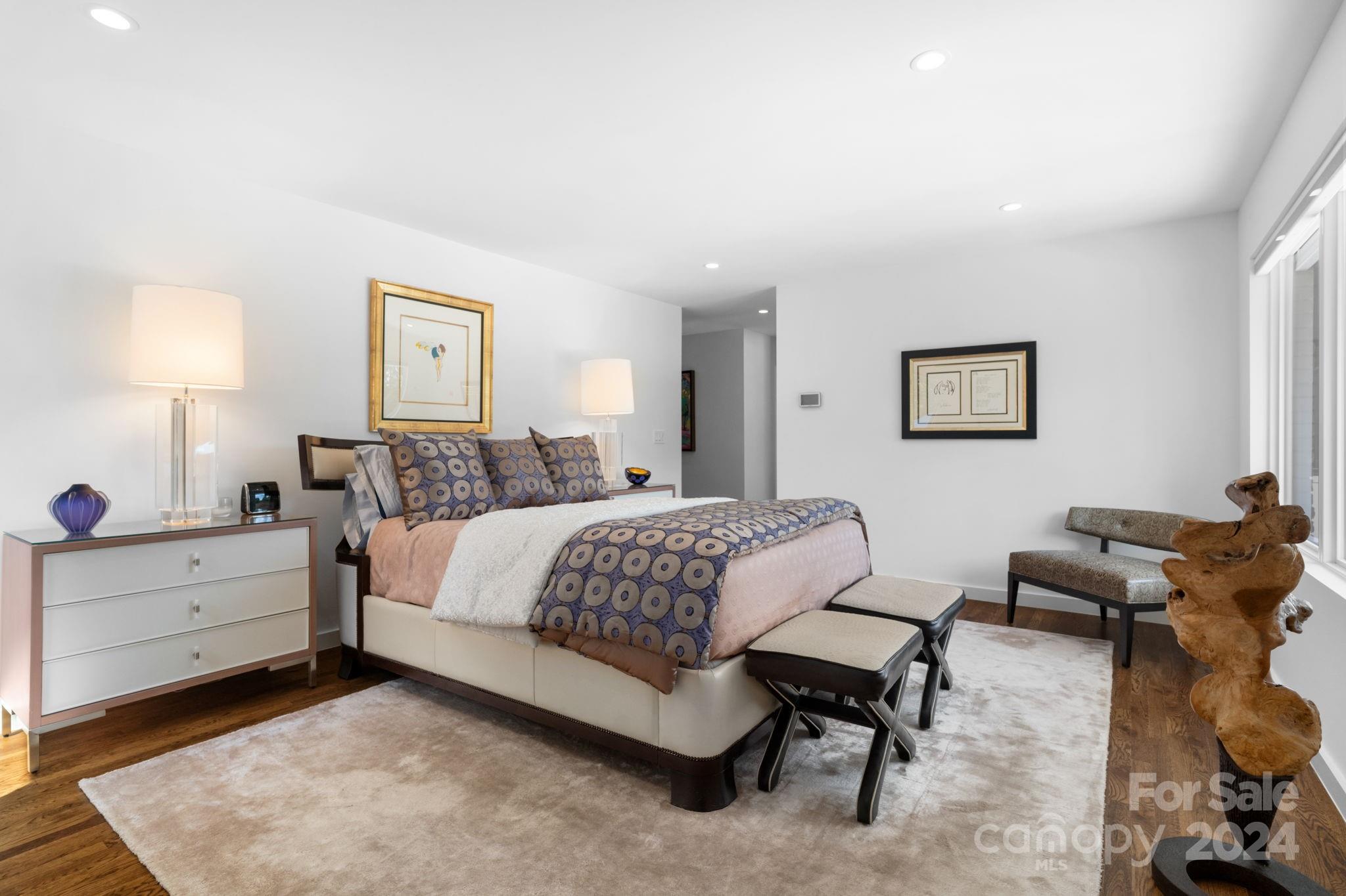 4142 Oldfield Road Charlotte, NC 28226 - Photo 28 of 48 a spacious bedroom with a bed and lamp