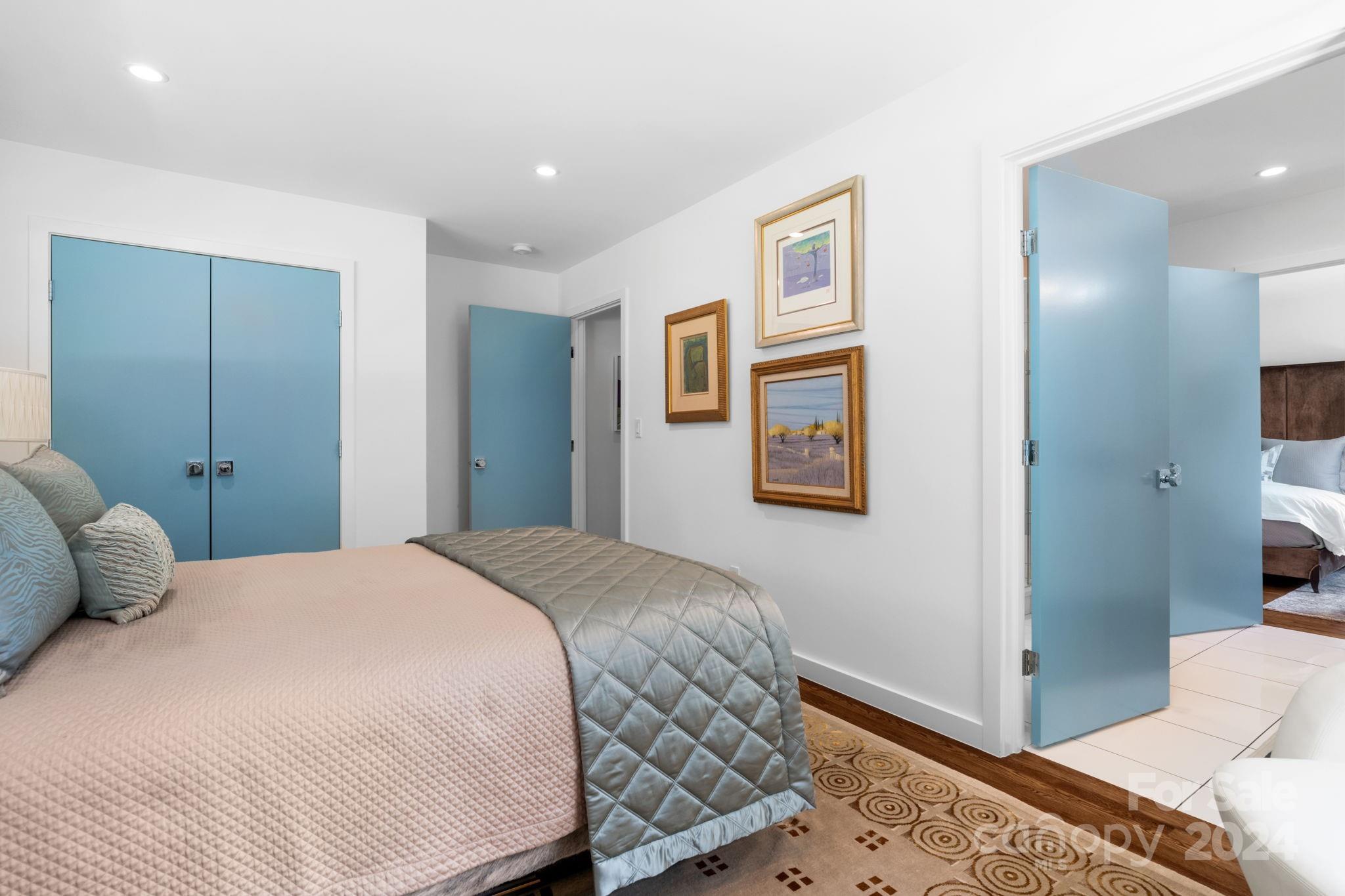 4142 Oldfield Road Charlotte, NC 28226 - Photo 34 of 48 a bedroom with a large bed and a chandelier