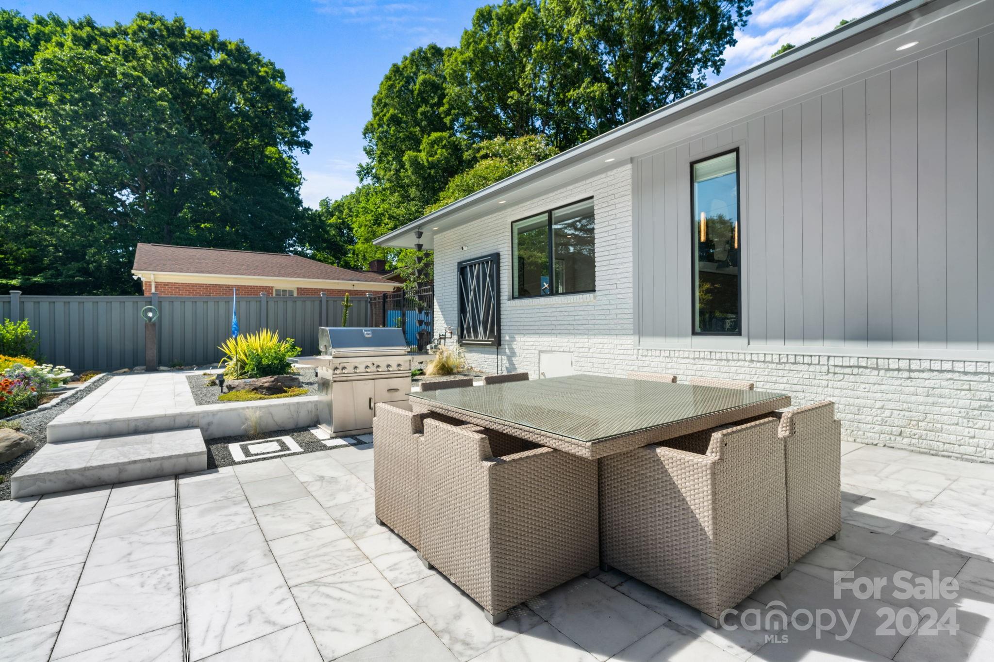 4142 Oldfield Road Charlotte, NC 28226 - Photo 41 of 48 a view of a patio with couches table and chairs and potted plants