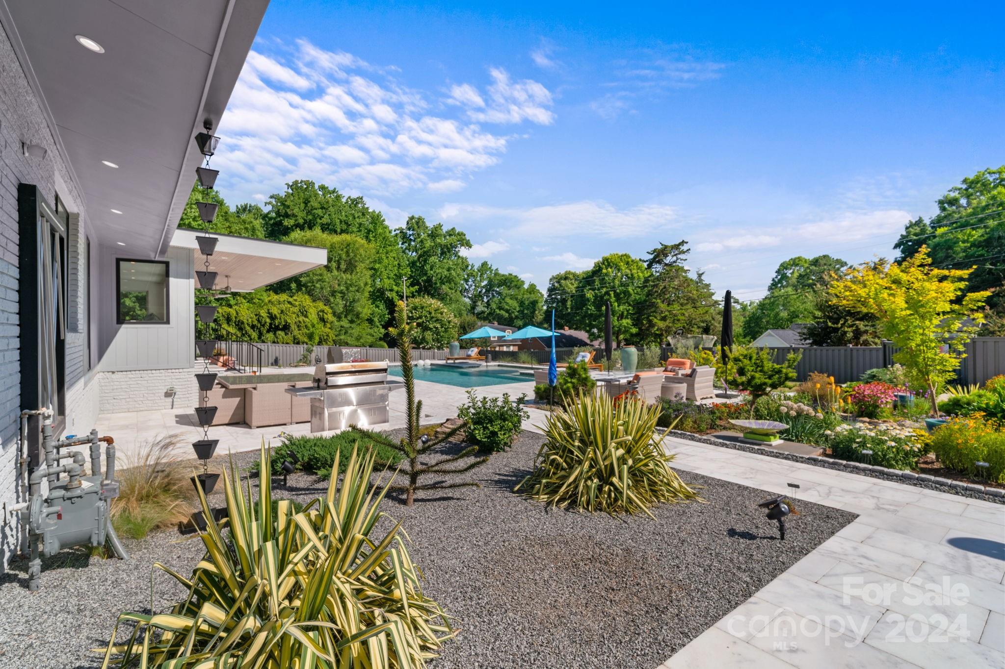 4142 Oldfield Road Charlotte, NC 28226 - Photo 42 of 48 a view of a patio with table and chairs potted plants