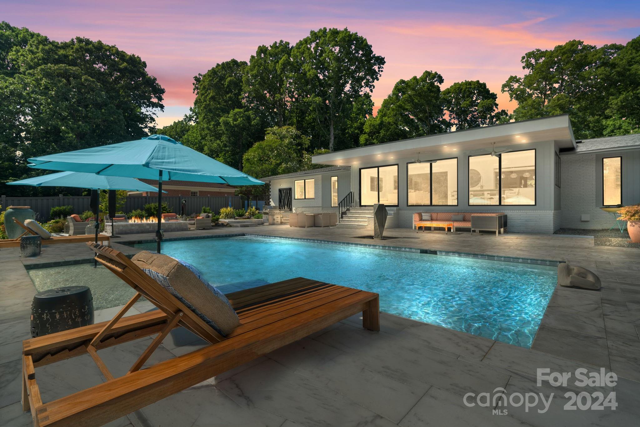 4142 Oldfield Road Charlotte, NC 28226 - Photo 45 of 48 a view of swimming pool with outdoor seating and trees in the background