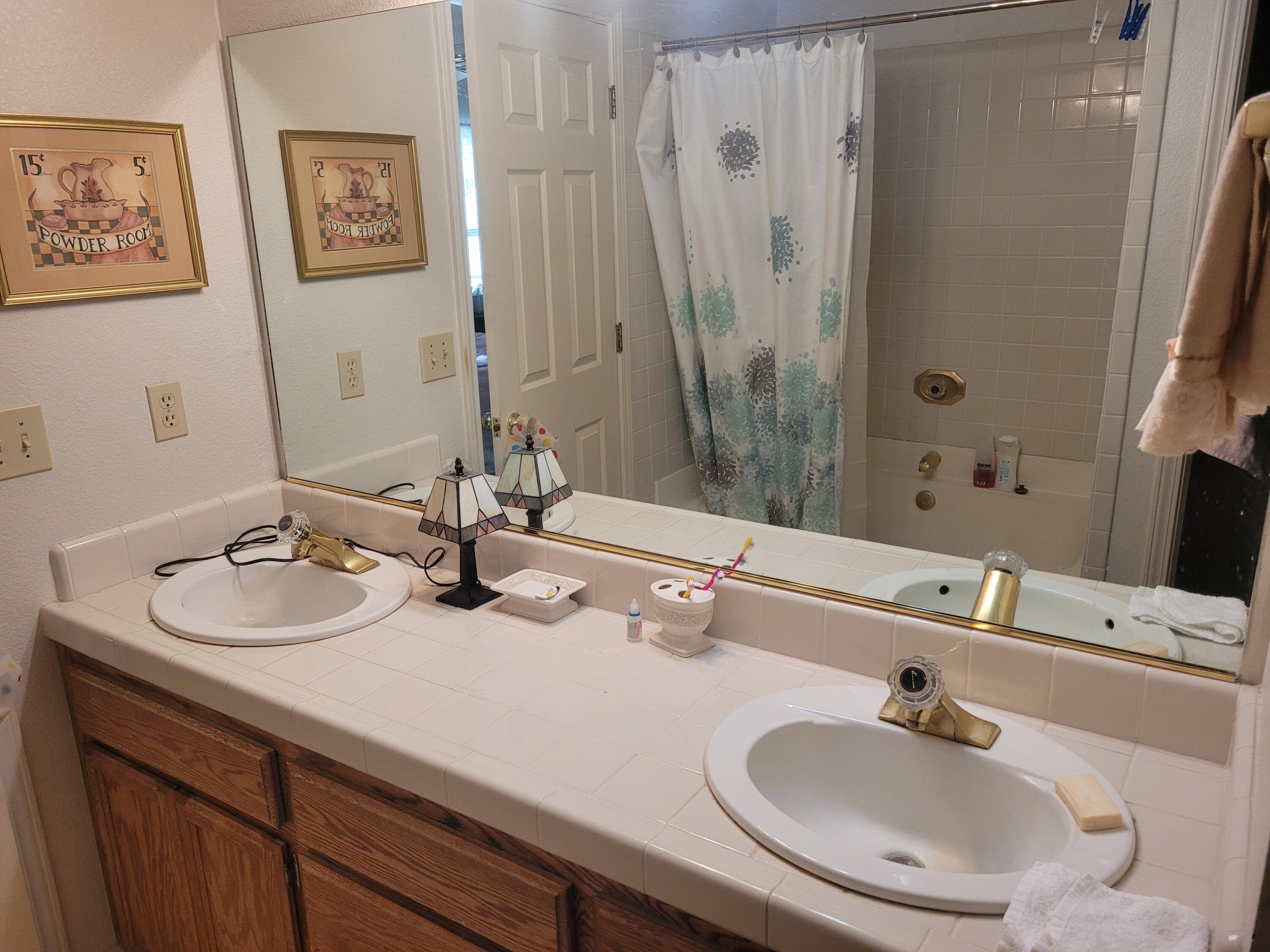4979 Tralee Lane Redding, CA 96001 - Photo 16 of 19 a bathroom with a sink and a mirror