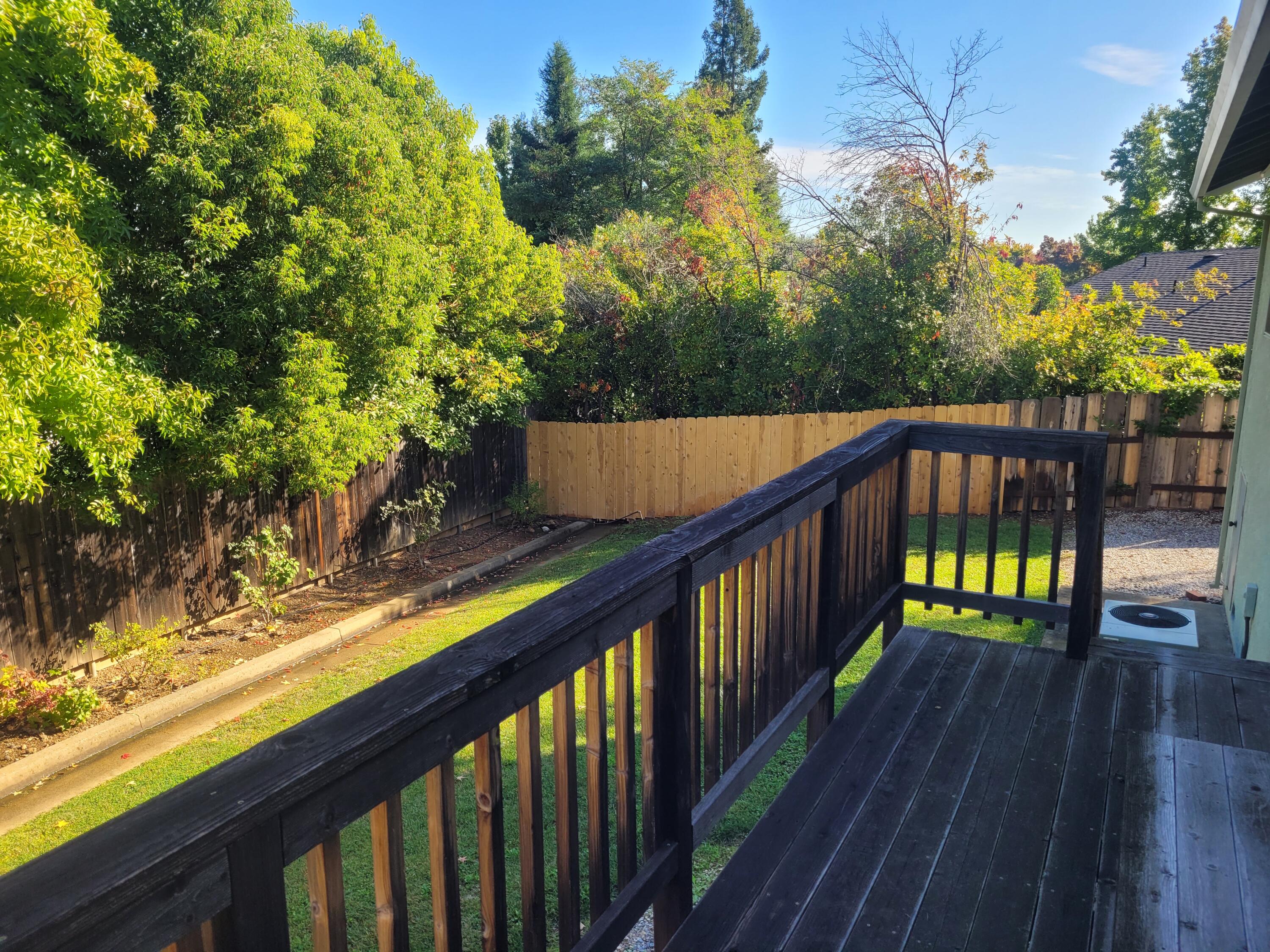 4979 Tralee Lane Redding, CA 96001 - Photo 17 of 19 a balcony with wooden floor and yard in the back