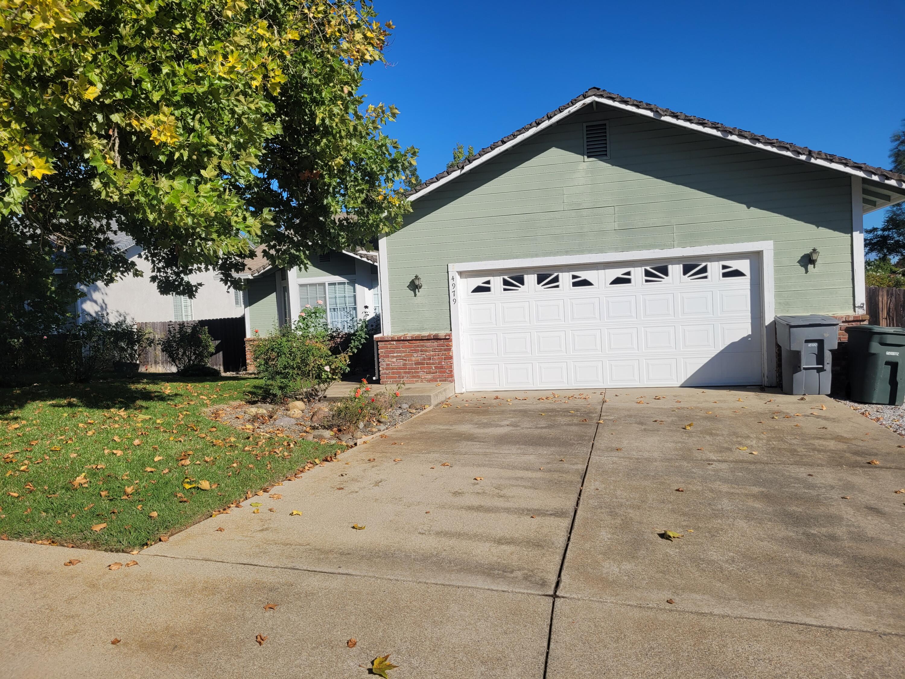 4979 Tralee Lane Redding, CA 96001 - Photo 2 of 19 a front view of a house with a yard