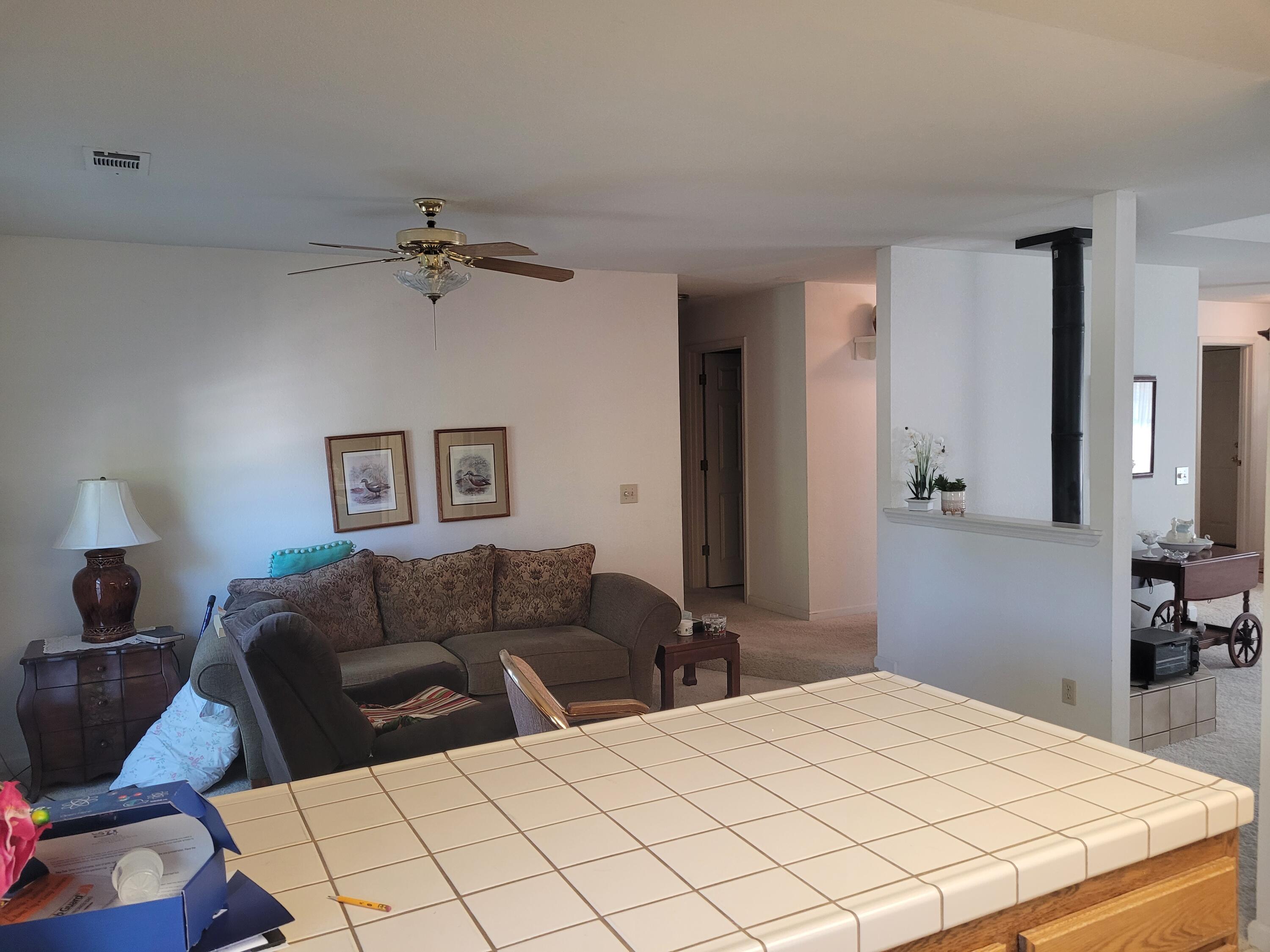 4979 Tralee Lane Redding, CA 96001 - Photo 9 of 19 a bedroom with a bed couches and a flat tv screen