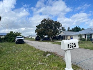1625 2nd Avenue Southwest Vero Beach, FL 32962 - Photo 13 of 17 a front view of a house with a yard and garage