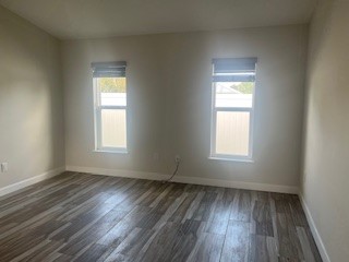 1625 2nd Avenue Southwest Vero Beach, FL 32962 - Photo 2 of 17 an empty room with wooden floor and windows