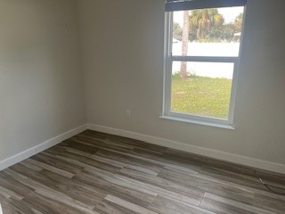 1625 2nd Avenue Southwest Vero Beach, FL 32962 - Photo 6 of 17 a view of an empty room with wooden floor and a window