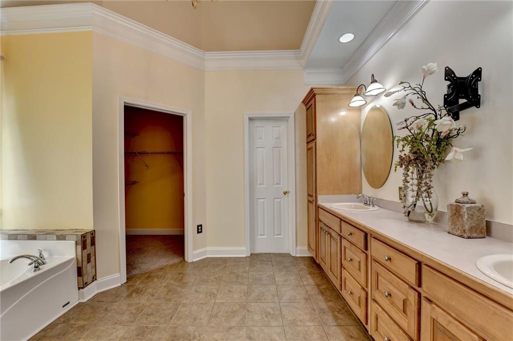 1031 Riverside Road Sugar Hill, GA 30518 - Photo 25 of 109 a bathroom with a double vanity sink and a mirror
