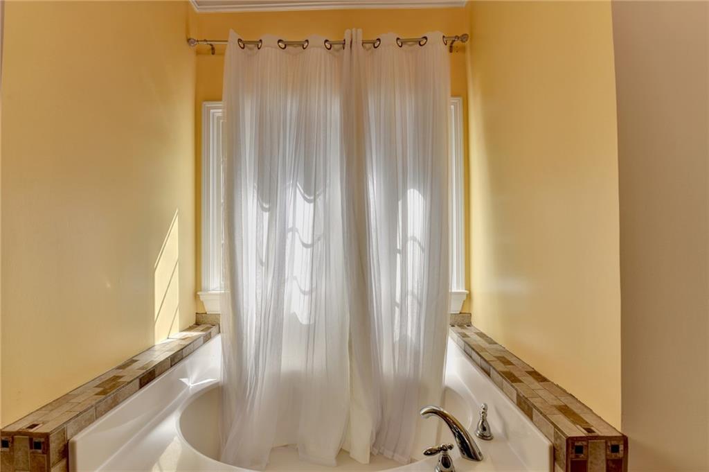 1031 Riverside Road Sugar Hill, GA 30518 - Photo 26 of 109 a view of a bathroom with a tub and sink
