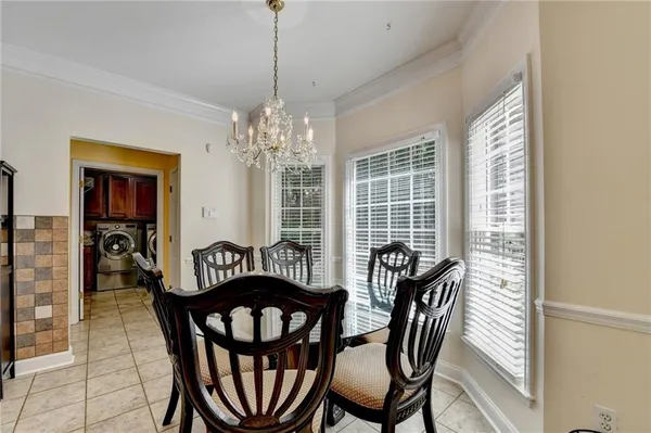 a living room with furniture a rug and white walls