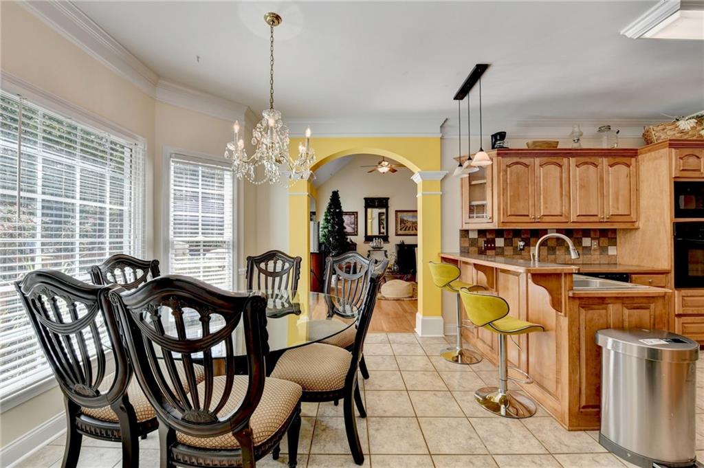 1031 Riverside Road Sugar Hill, GA 30518 - Photo 34 of 109 a view of a dining room with furniture and chandelier