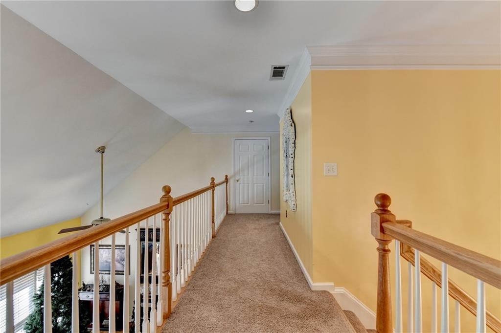 1031 Riverside Road Sugar Hill, GA 30518 - Photo 45 of 109 a view of a hallway with wooden floor and stairs