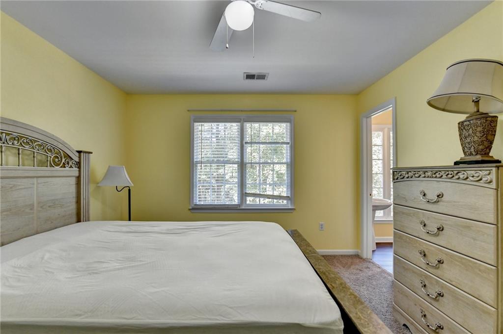 1031 Riverside Road Sugar Hill, GA 30518 - Photo 59 of 109 a bedroom with a bed and a dresser