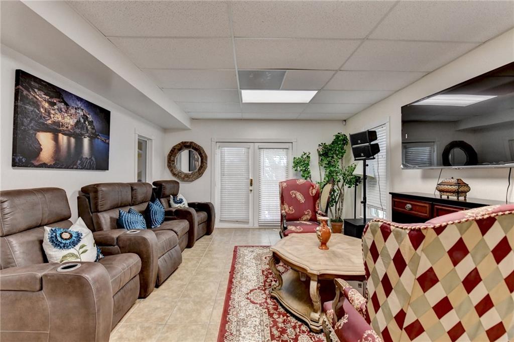 1031 Riverside Road Sugar Hill, GA 30518 - Photo 68 of 109 a living room with furniture a rug and white walls