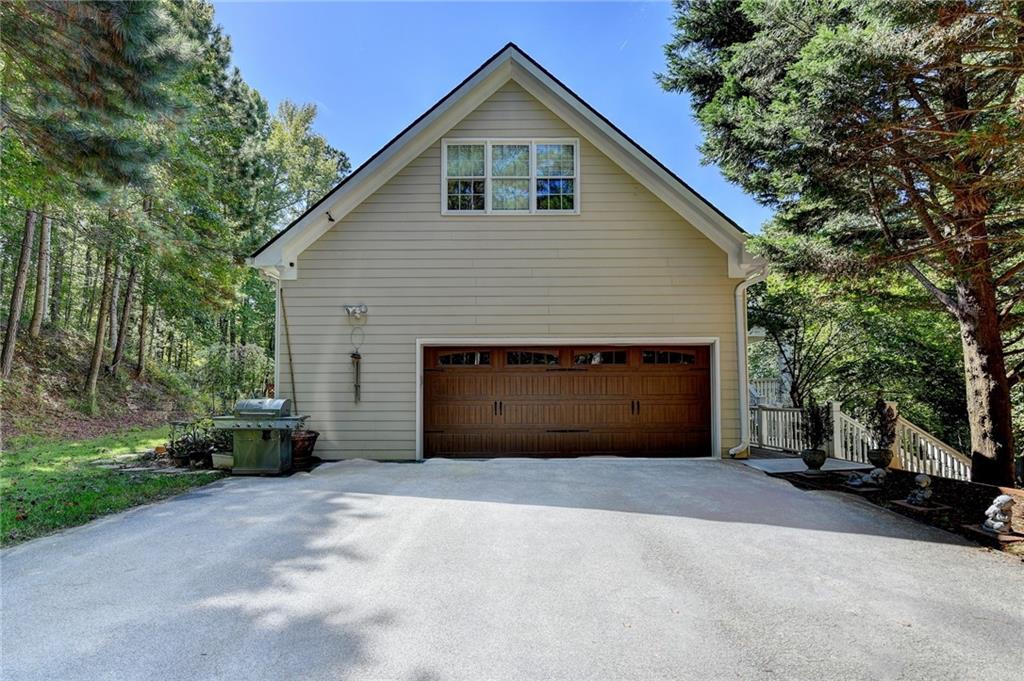 1031 Riverside Road Sugar Hill, GA 30518 - Photo 90 of 109 a front view of a house with a garden