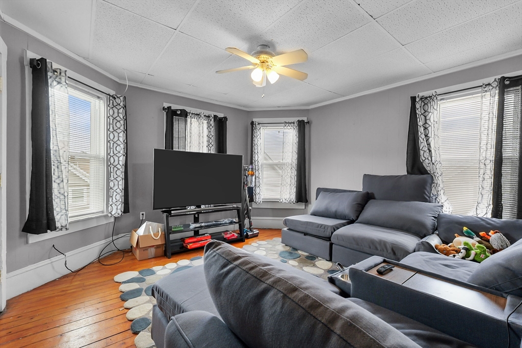 146 Hunter Street Fall River, MA 02721 - Photo 2 of 41 a living room with furniture and a flat screen tv with wooden floor