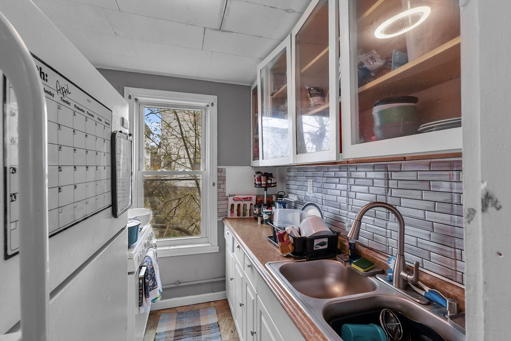 146 Hunter Street Fall River, MA 02721 - Photo 21 of 41 a kitchen with a sink appliances cabinets and a large window
