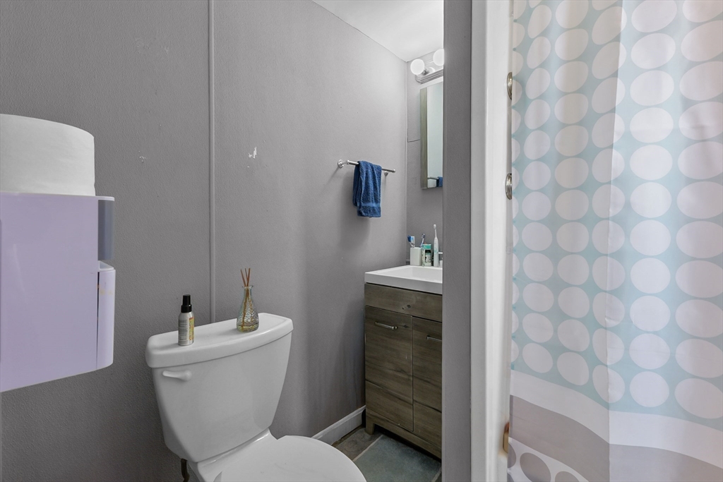 146 Hunter Street Fall River, MA 02721 - Photo 26 of 41 a bathroom with a toilet a sink and mirror