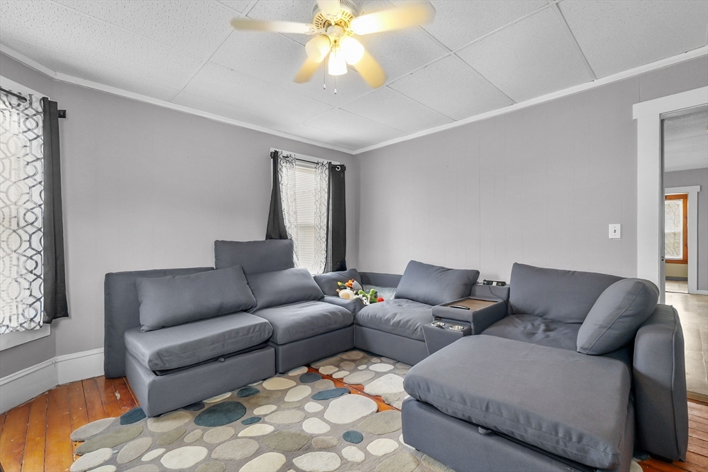 146 Hunter Street Fall River, MA 02721 - Photo 3 of 41 a living room with furniture and a chandelier