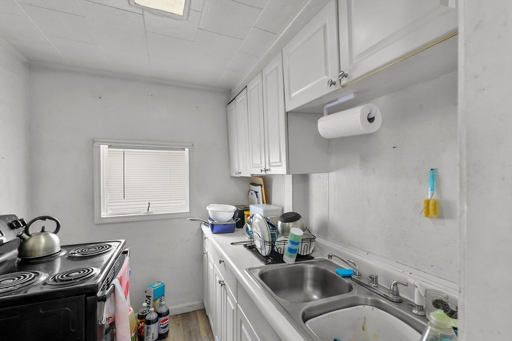 146 Hunter Street Fall River, MA 02721 - Photo 33 of 41 a kitchen with stainless steel appliances a sink a stove and cabinets