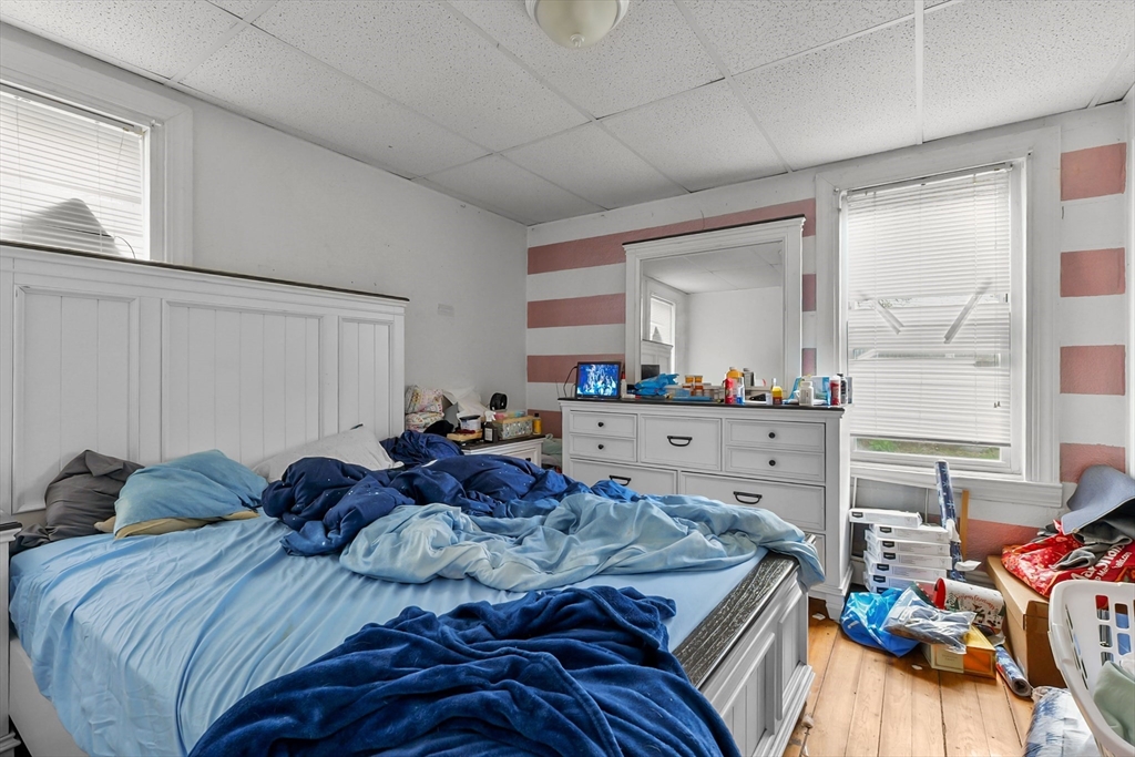 146 Hunter Street Fall River, MA 02721 - Photo 36 of 41 a bedroom with a bed a dresser and potted plants
