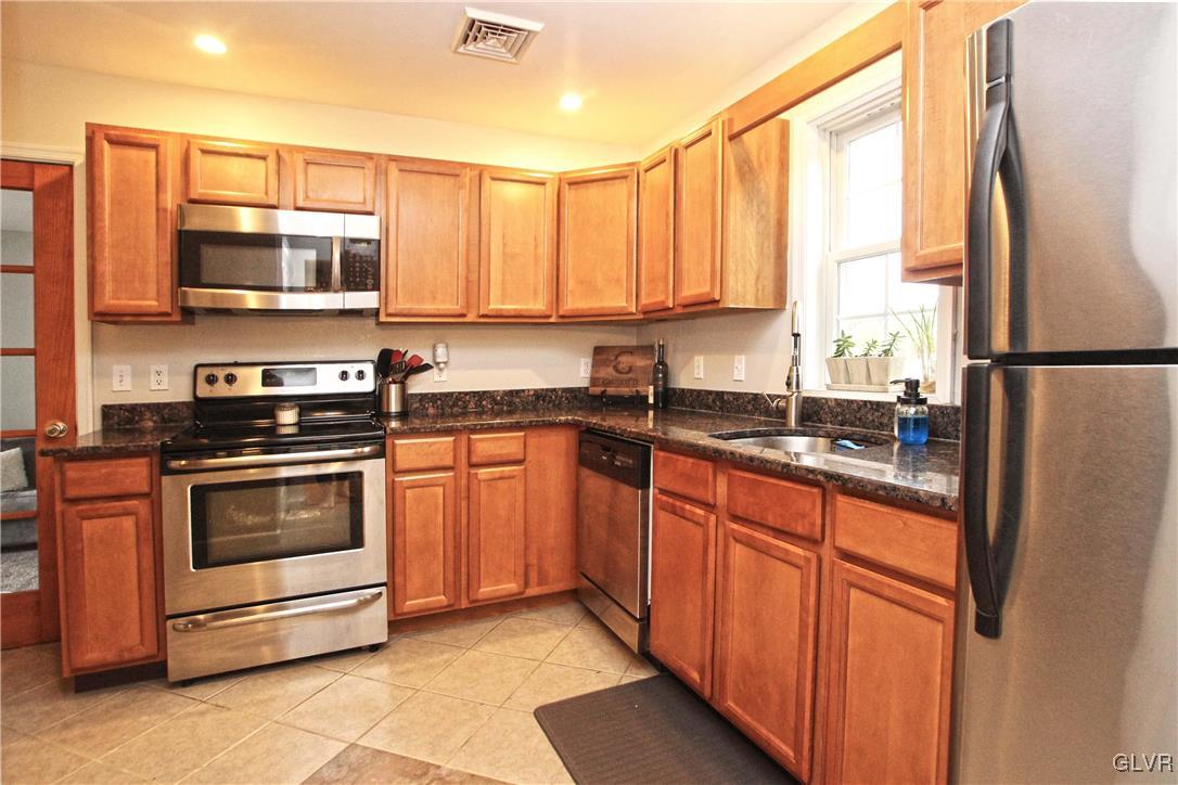 508 Weir Mountain Road Gilbert, PA 18331 - Photo 15 of 37 a kitchen with stainless steel appliances granite countertop a refrigerator a stove a sink and a microwave
