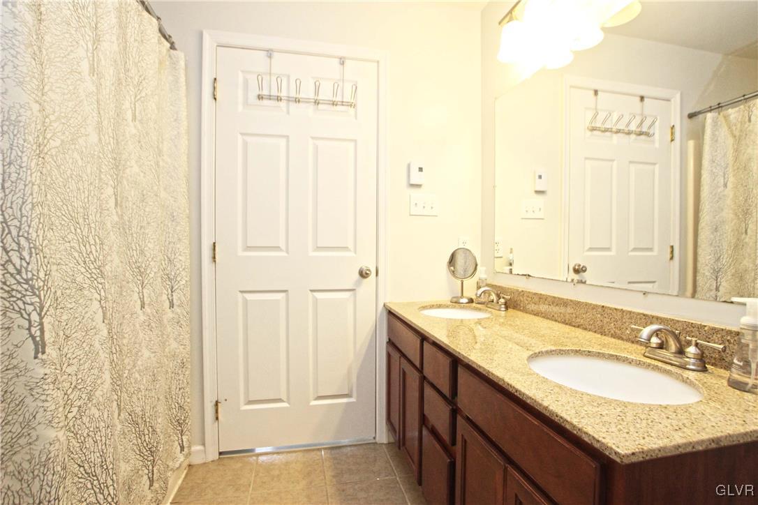 508 Weir Mountain Road Gilbert, PA 18331 - Photo 26 of 37 a bathroom with a granite countertop sink and a mirror