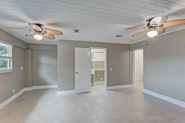 a view of an empty room with a ceiling fan