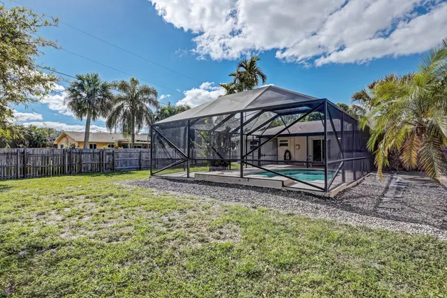 a view of a house with a yard and sitting area