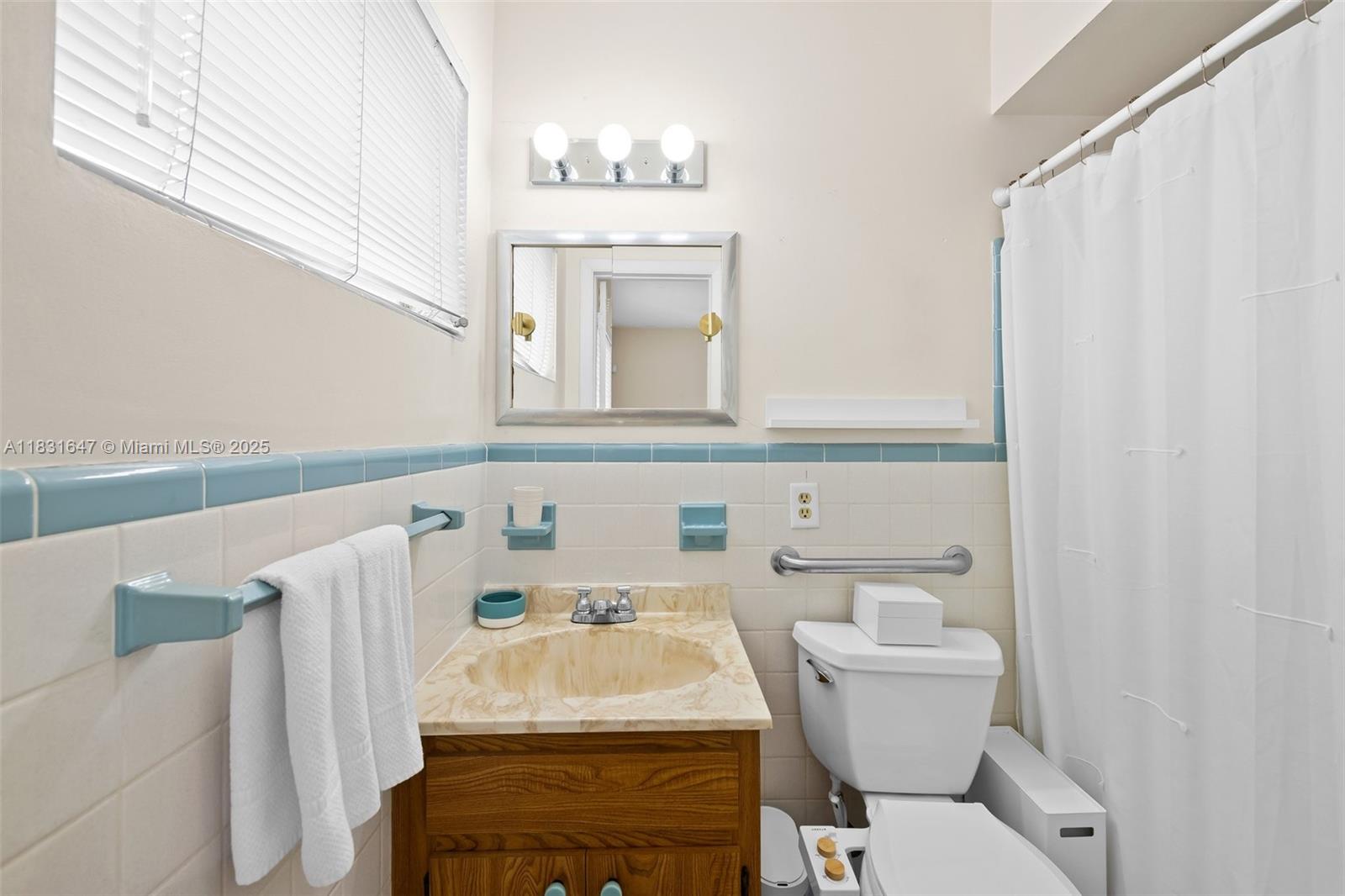 2015 North 37th Avenue Hollywood, FL 33021 - Photo 11 of 16 a bathroom with a toilet sink and mirror