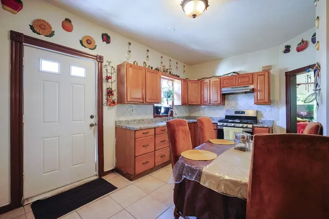 a kitchen with granite countertop a sink stove and cabinets