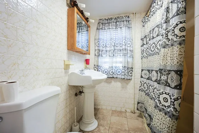 a bathroom with a sink and a shower curtain