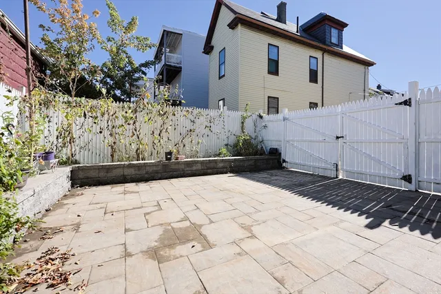 a view of a white house with a yard