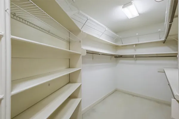 an empty room with chandelier fan