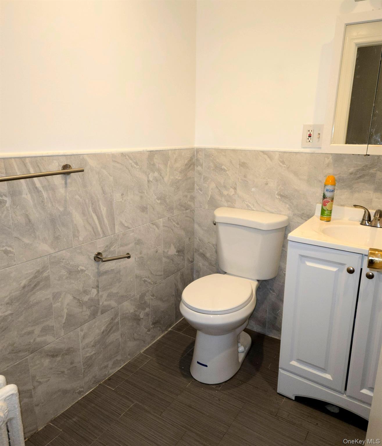 91-45 85th Street Queens, NY 11421 - Photo 11 of 15 a bathroom with a toilet a sink and a mirror