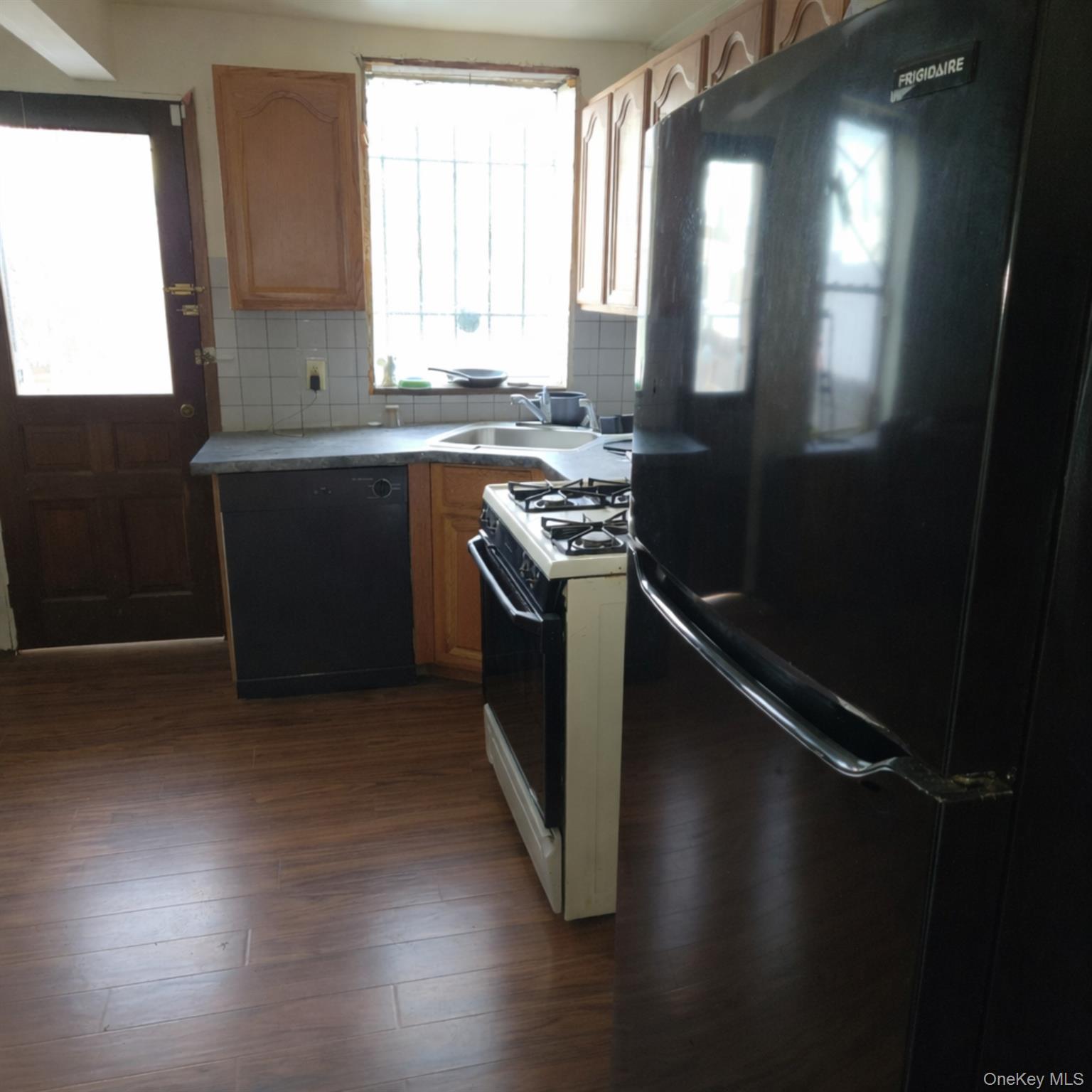 91-45 85th Street Queens, NY 11421 - Photo 8 of 15 a kitchen with granite countertop a stove and a sink