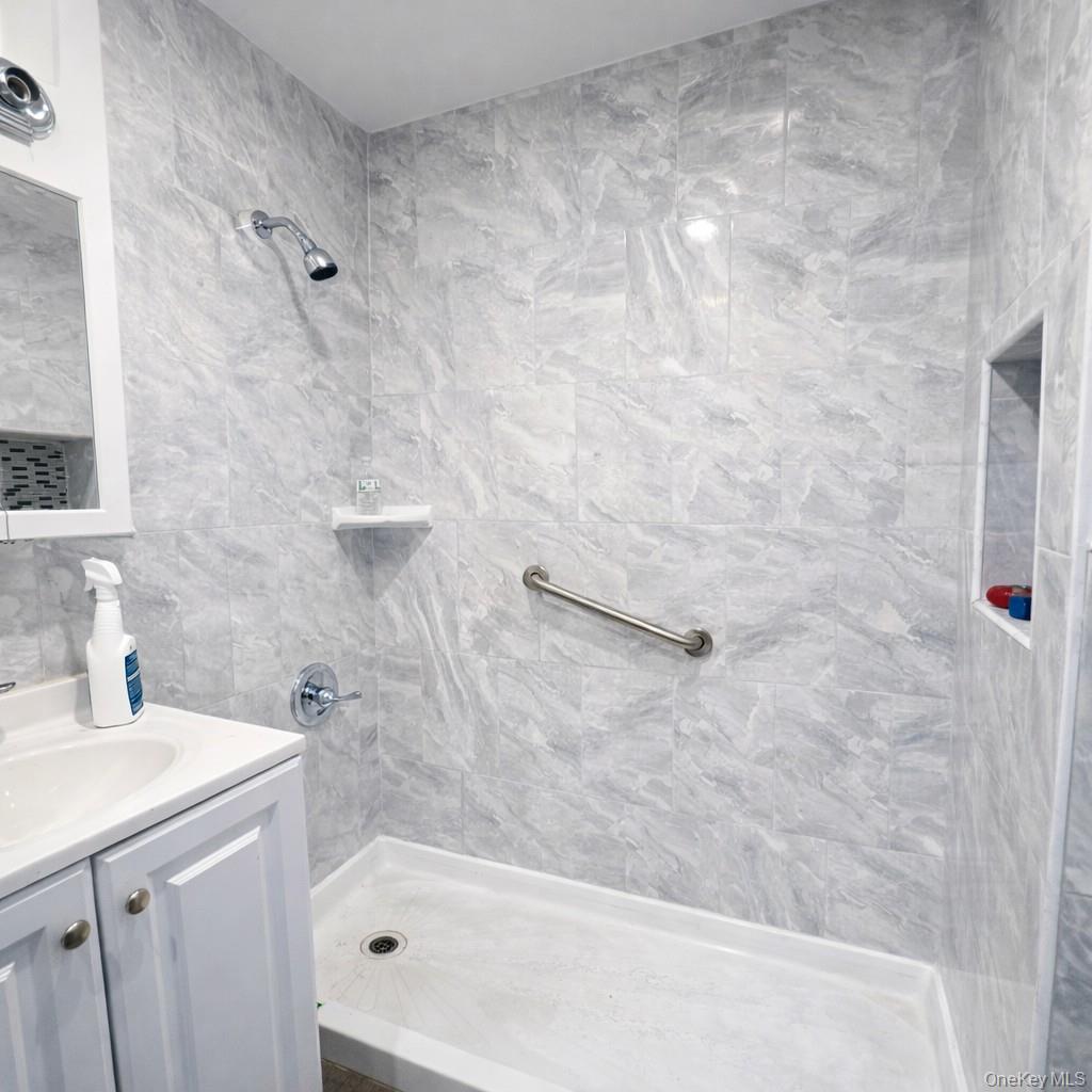 91-45 85th Street Queens, NY 11421 - Photo 10 of 15 a bathroom with a bathtub and sink