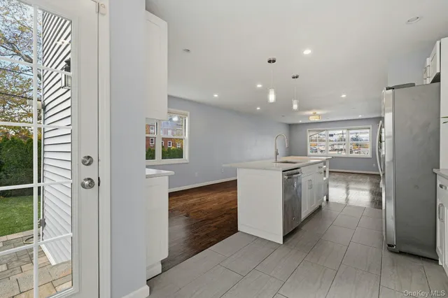a kitchen with a refrigerator and a stove top oven