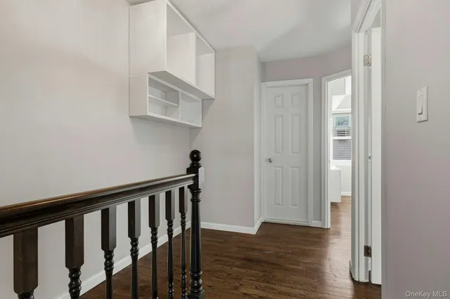 a view of a hallway with wooden floor and entryway