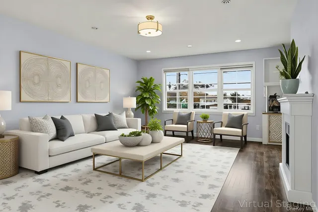 a living room with furniture potted plant and a large window
