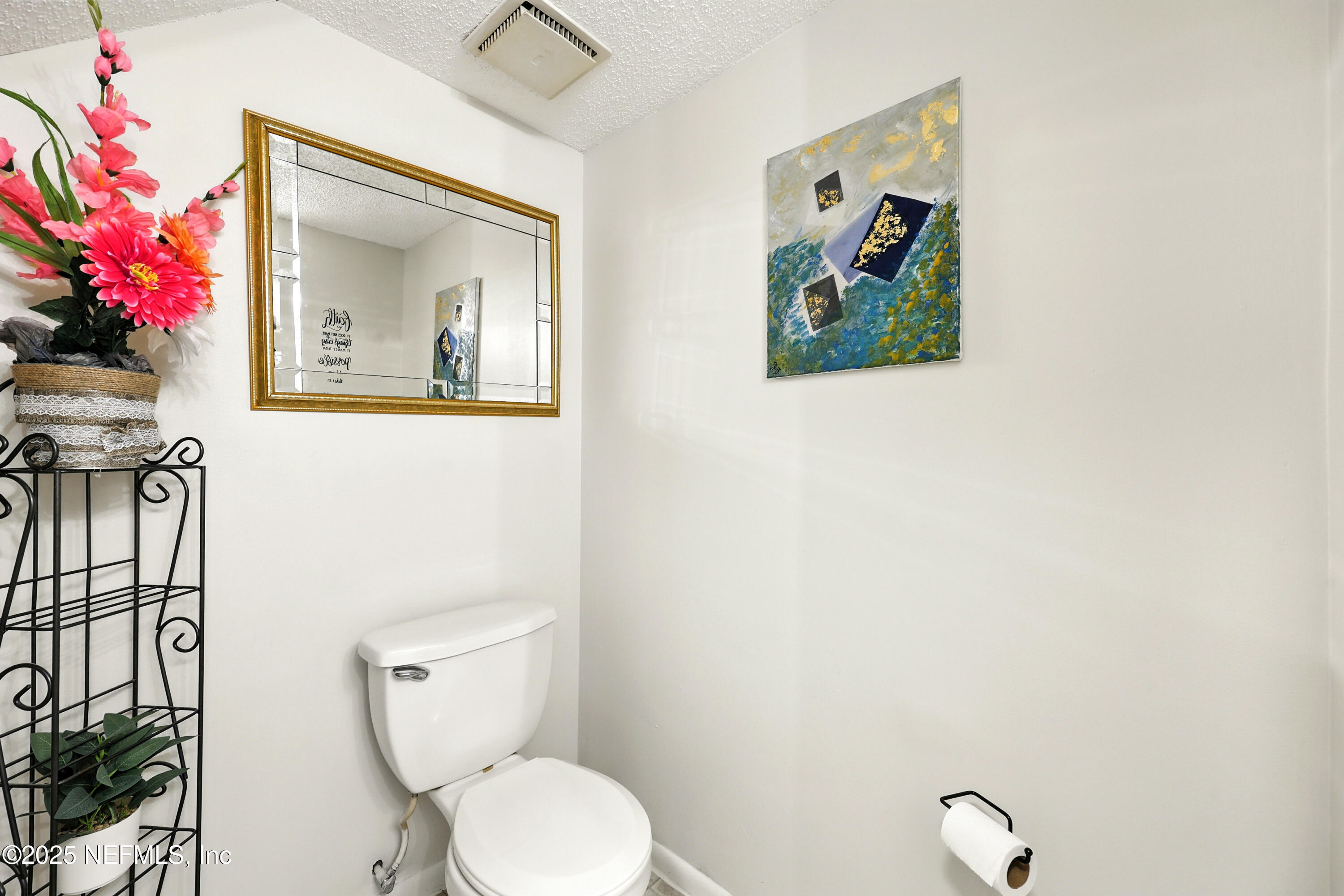 504 Kettering Way Orange Park, FL 32073 - Photo 13 of 27 a bathroom with a toilet a sink and mirror