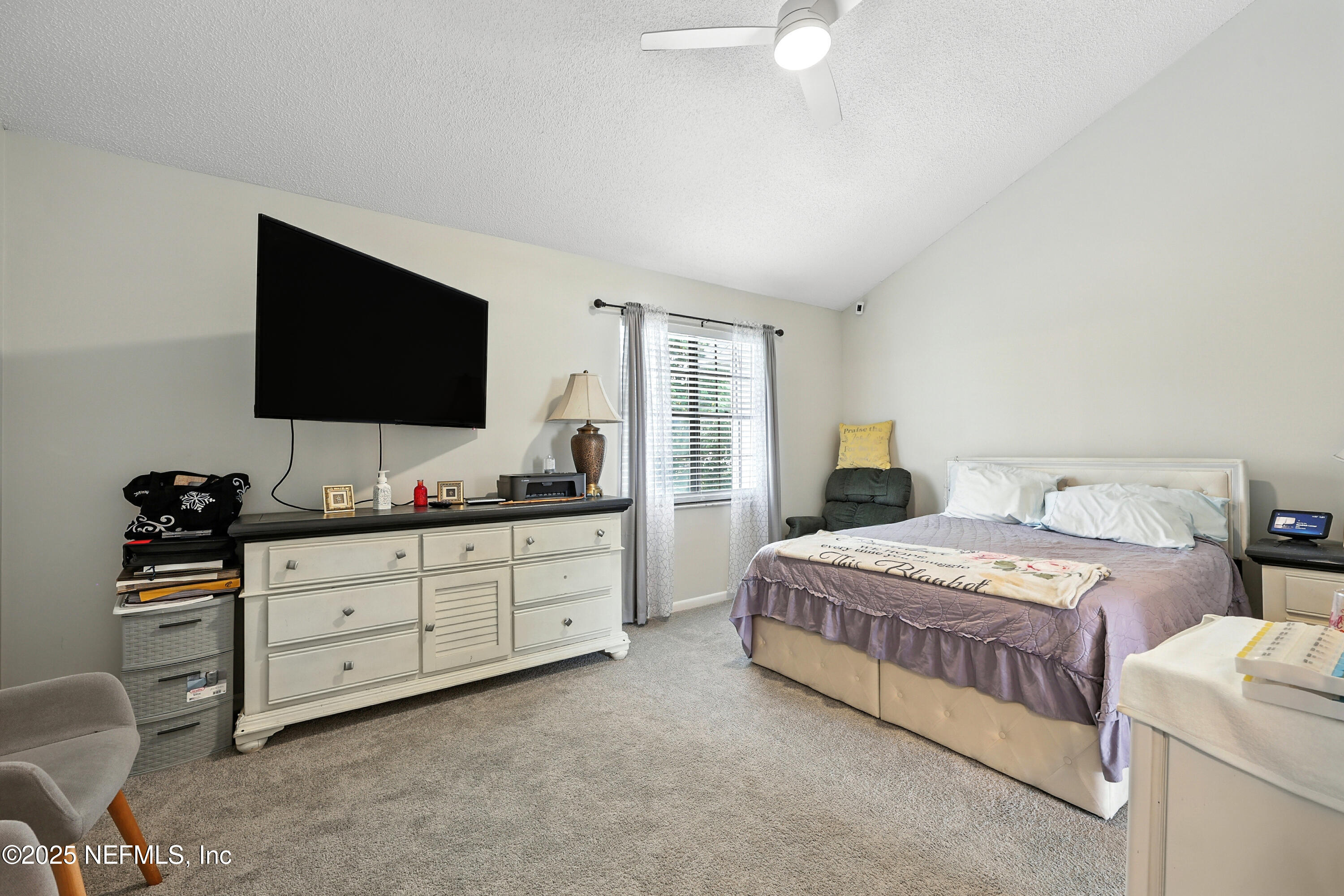 504 Kettering Way Orange Park, FL 32073 - Photo 15 of 27 a bedroom with a bed and a flat screen tv
