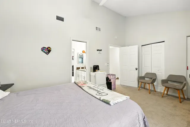 a bedroom with a bed and a chair