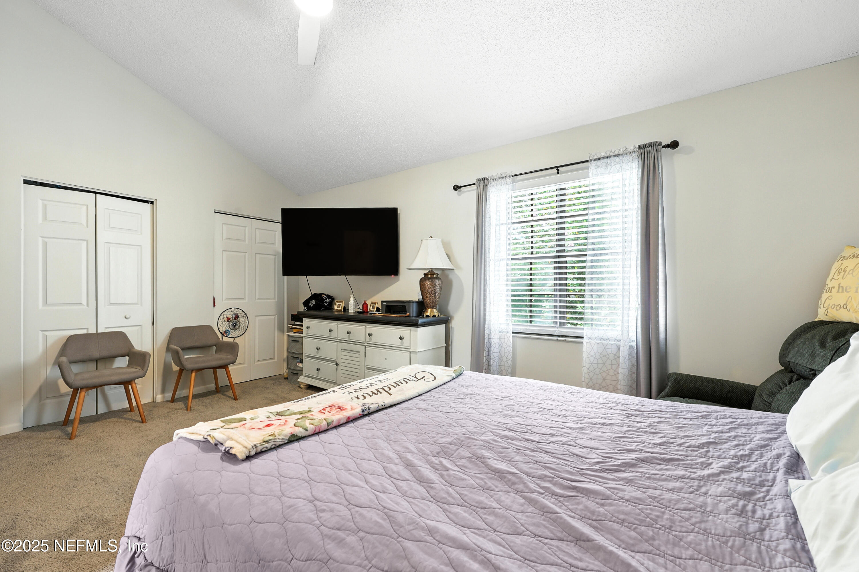 504 Kettering Way Orange Park, FL 32073 - Photo 18 of 27 a bedroom with a bed and a flat screen tv