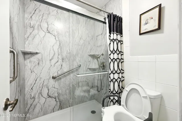 a bathroom with a bathtub and shower