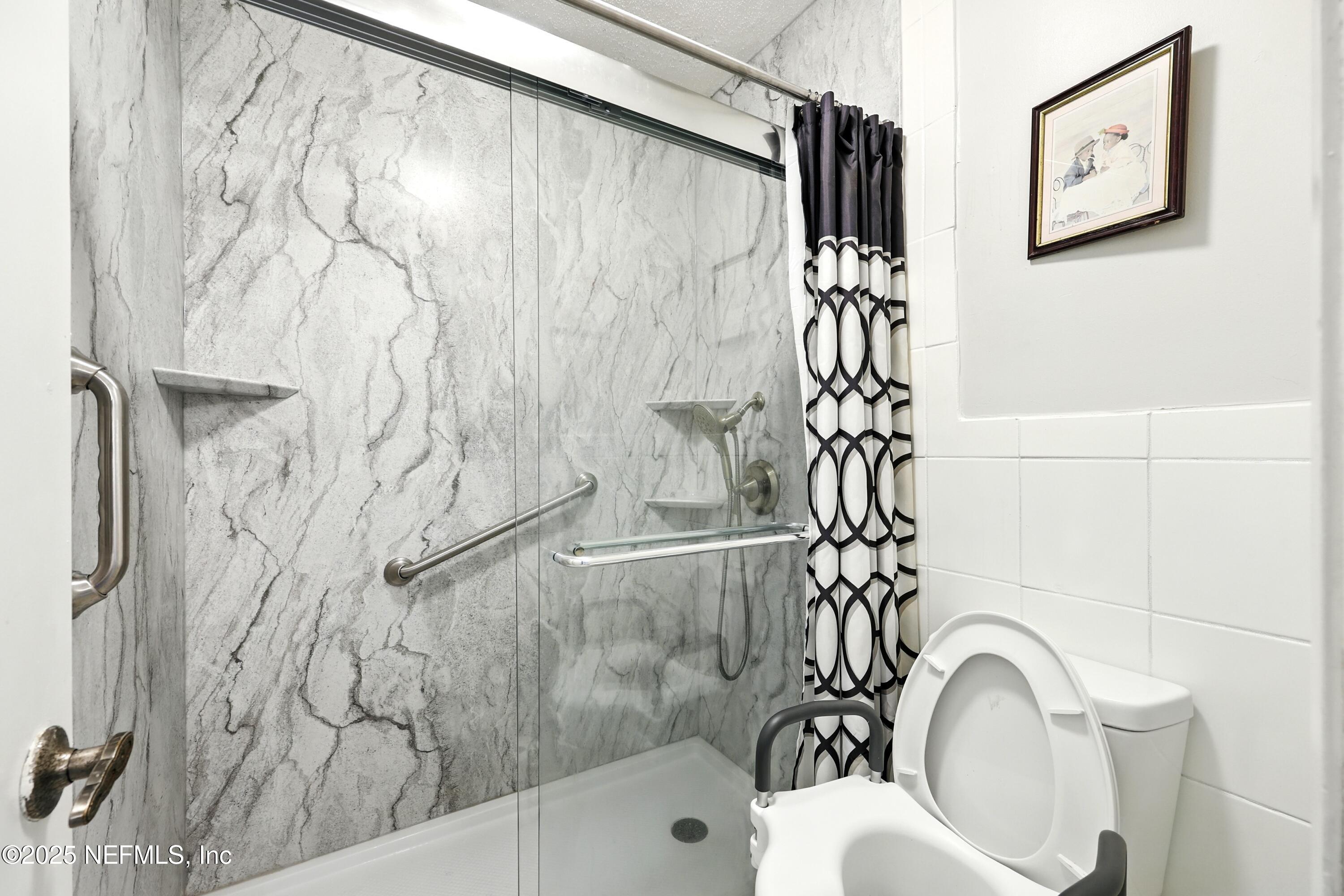 504 Kettering Way Orange Park, FL 32073 - Photo 20 of 27 a bathroom with a bathtub and shower